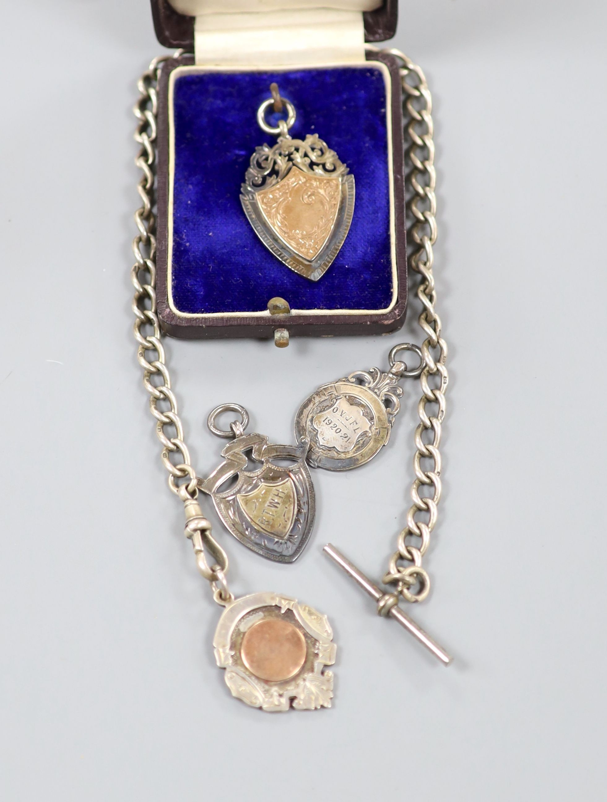 A 1940's silver cased propelling pencil, four assorted silver medallions and a silver albert.
